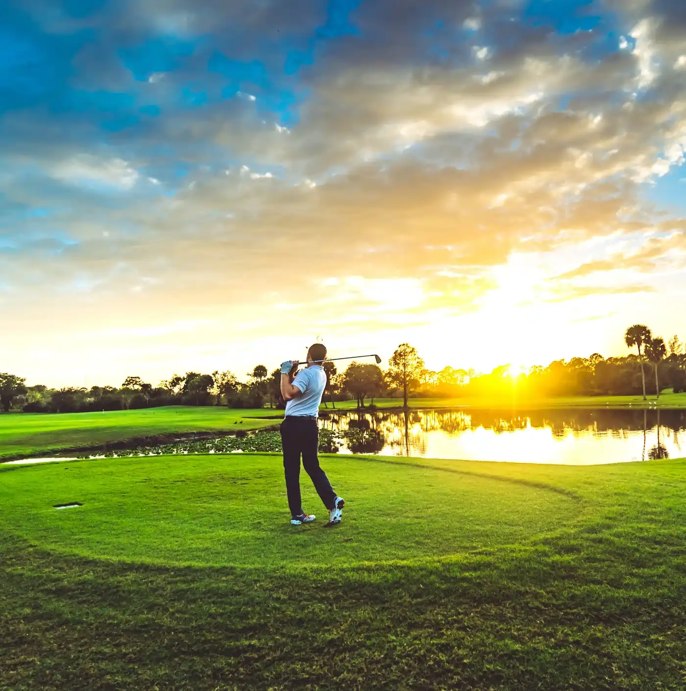Golfers at sunset on a private championship course in Naples Florida