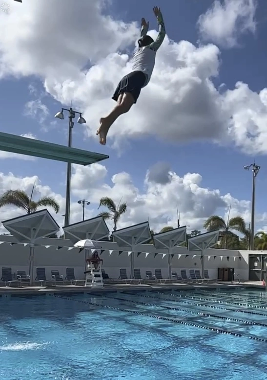 kid jumping of diving board river park aquatic center kid jumping of diving board river park aquatic center