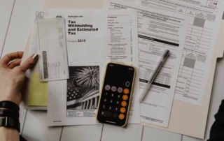 Financial documents and a calculator representing condo association due diligence in Naples, Florida