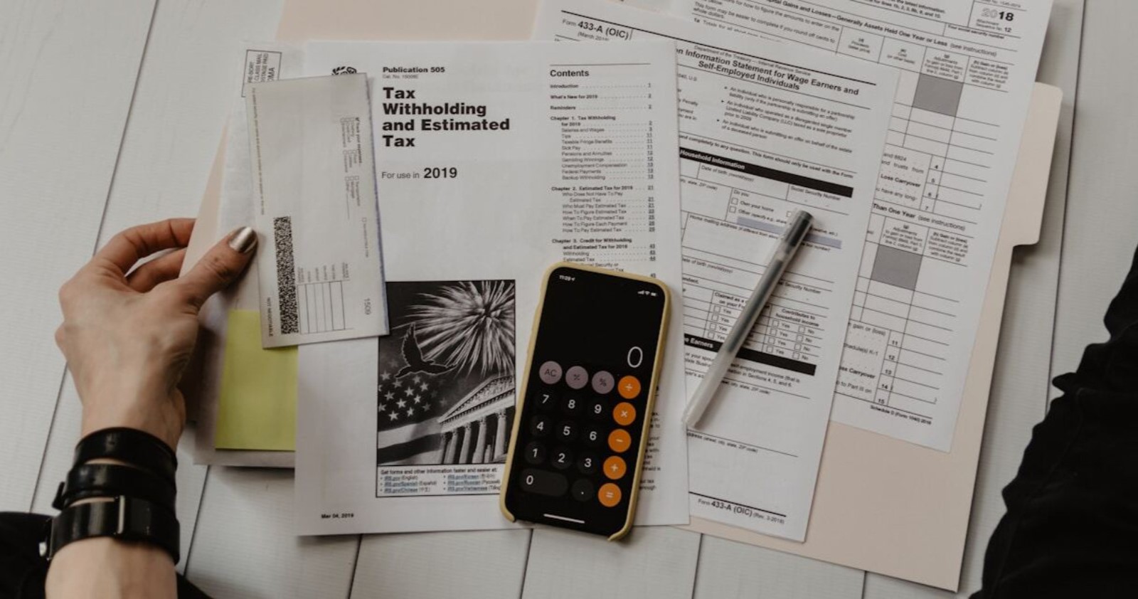 Financial documents and a calculator representing condo association due diligence in Naples, Florida