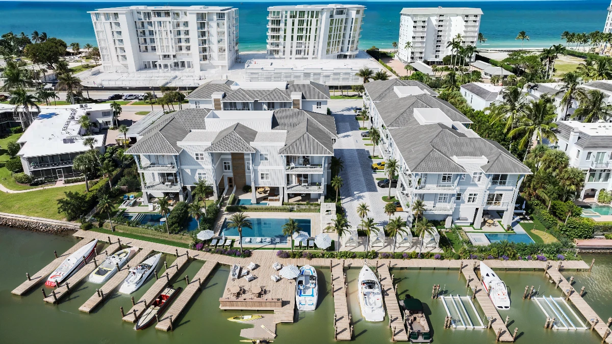 Harbour House Naples waterfront view with private boat slips and overwater amenity deck on Naples Bay