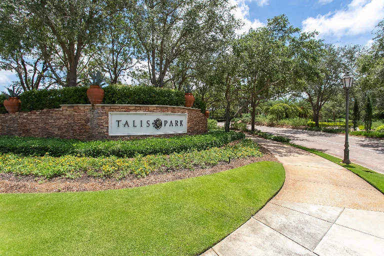 Talis Park entrance sign surrounded by landscaping in Naples, Florida